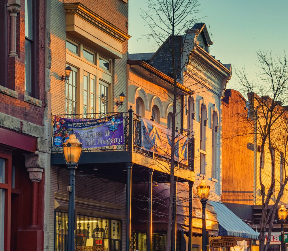 Storefronts in a downtown area during golden hour.