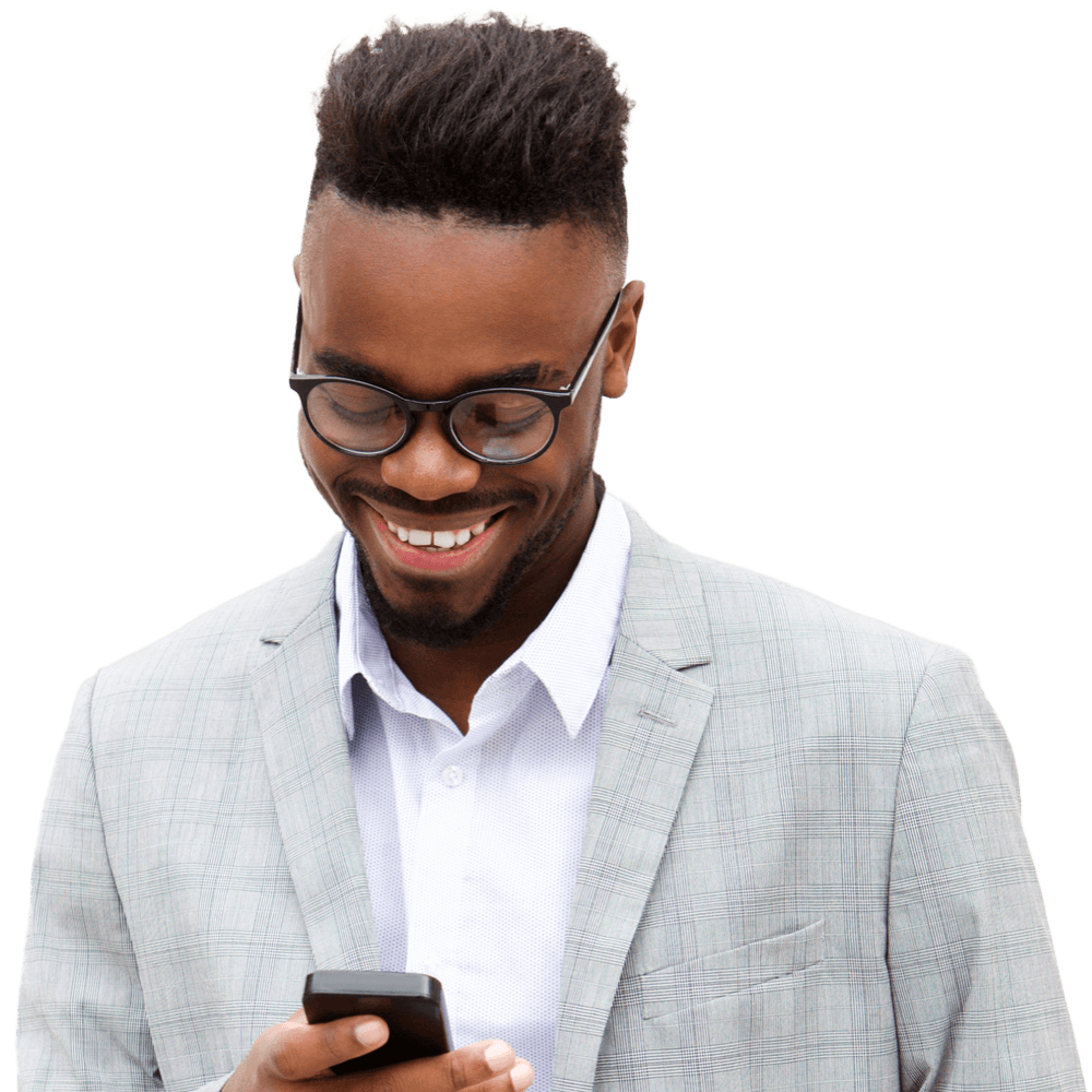 A smiling Black man is holding and looking at his smartphone.