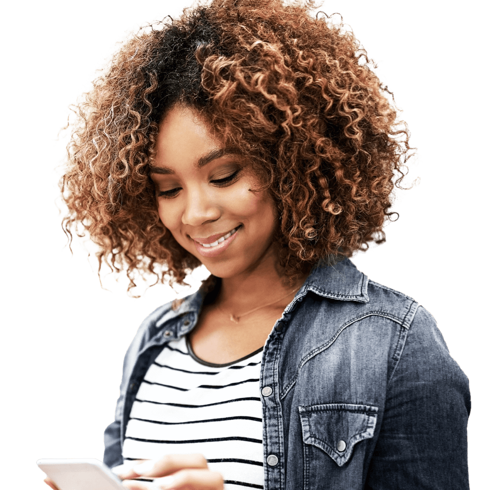 A Black woman is looking at her smart phone and smiling.